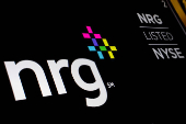 FILE PHOTO: NRG Energy Inc. logo is displayed on a screen on the floor of the NYSE in New York