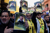 Mourners react during the funeral of Hezbollah commander Al-Hajj Mustafa Abdel Latif al-Zein, after a ceasefire agreement between Hezbollah and Israel took effect, in Beirut