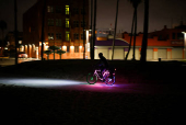 A man rides a bike along Venice Beach