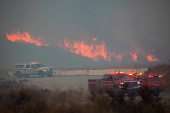 Firefighters and aircraft battle the Hughes Fire near Santa Clarita