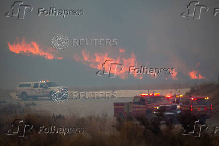 Firefighters and aircraft battle the Hughes Fire near Santa Clarita