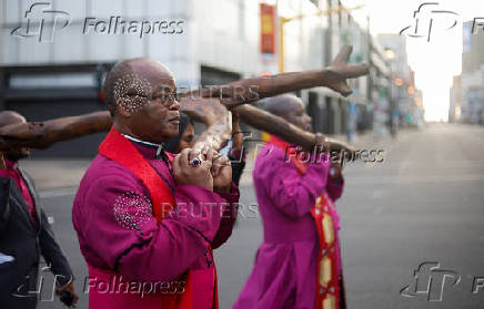 Religious leaders carry a cross during a silent Good Friday procession in Durban