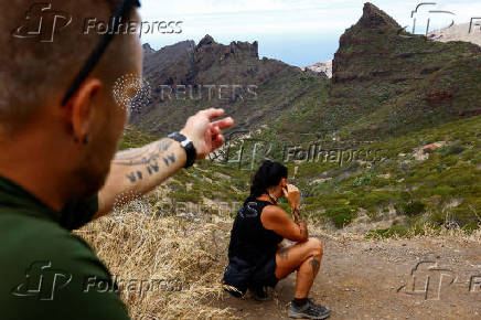 Czech tourists Martin, 42, and Jana, 47, watch the search work of young Briton Jay Slater in the Masca ravine