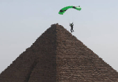 Professional skydivers fly over the historical site of Giza Pyramids, during Egypt International Skydiving Festival 