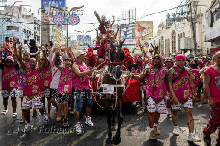 Filipino Catholics participate in the parade of Black Nazarene replicas