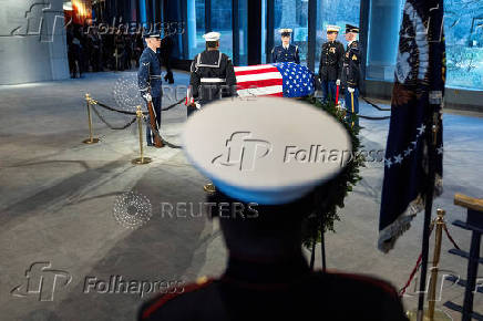 Mourners view the casket of former U.S. President Jimmy Carter as he lies in repose at the Jimmy Carter Presidential Library and Museum