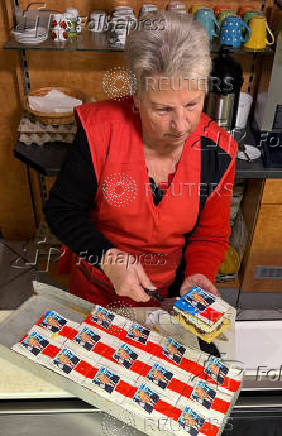 Ursula Trump presents pastries decorated with an eatable portrait of U.S. President-elect Donald Trump in a bakery in Freinsheim