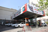 Cars are seen in a gas station in Tehran