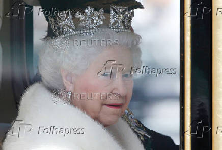 FILE PHOTO: Britain's Queen Elizabeth is driven by carriage from Buckingham Palace to the Houses of Parliament during the State Opening of Parliament in central London