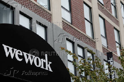 FILE PHOTO: FILE PHOTO: A WeWork logo is seen outside its offices in the Queens borough of New York City