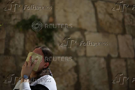 Jewish worshippers pray at the Western Wall at the Old City of Jerusalem