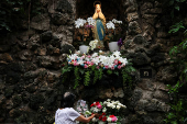 A woman arranges flowers to prepare for the Christmas mass at the Jakarta Cathedral in Jakarta