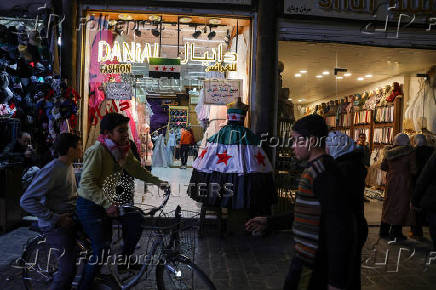 A dress with a flag motif adopted by the new Syrian rulers is displayed, after Syria's Bashar al-Assad was ousted, in Damascus