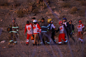 Rescue personnel carry the body of an agent of the National Institute of Migration (INM), in Ciudad Juarez