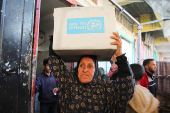 Palestinians receive aid following a ceasefire between Israel and Hamas, in Khan Younis in the southern Gaza Strip