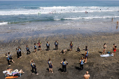 A group of tourists attend a surf class on Las Canteras Beach in Las Palmas de Gran Canaria