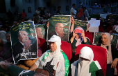 Supporters of Algeria's President and presidential candidate Abdelmadjid Tebboune look on during a campaigning rally in Algiers