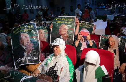 Supporters of Algeria's President and presidential candidate Abdelmadjid Tebboune look on during a campaigning rally in Algiers