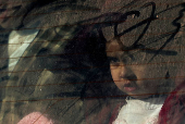 A child looks from a vehicle, in Damascus