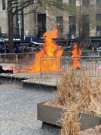 A person is covered in flames at a New York courthouse