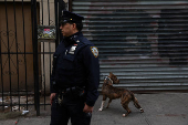 NYPD officer stands by OnPoint NYC in Harlem, New York City