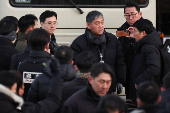 Members of the Corruption Investigation Office for High-ranking Officials gather in front of the impeached South Korean President Yoon Suk Yeol's official residence