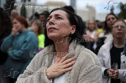 People gather ahead of the expected release of Israeli hostages, in Tel Aviv