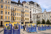 A man walks between memorial placards honouring fallen Ukrainian service members on St Sophia Square in central Kyiv