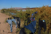 Migrants seeking asylum in the United States gather on the banks of the Rio Bravo river in Ciudad Juarez