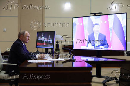 Russian President Vladimir Putin holds a video conference meeting with Chinese President Xi Jinping, outside Moscow