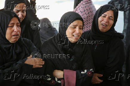 Palestinians mourn loved ones killed in Israeli strikes, in Khan Younis in the southern Gaza Strip