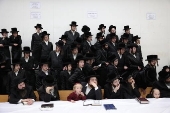 Ultra Orthodox Jews light Hanukkah holiday candles in Jerusalem