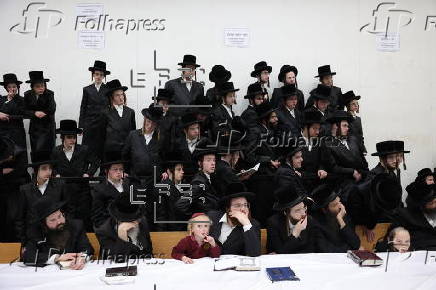 Ultra Orthodox Jews light Hanukkah holiday candles in Jerusalem