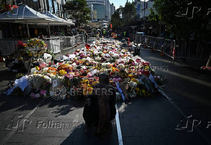 People leave floral tributes for victims of the attack at Westfield Bondi Junction shopping centre in Sydney