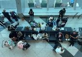 Passengers wait for their flight after a rainstorm hit Dubai, causing delays at the Dubai International Airport, in Dubai