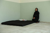 Rima Ali Chahine sits inside a class room at the Technical Institute of Bir Hassan, which has been turned into a shelter, in Beirut