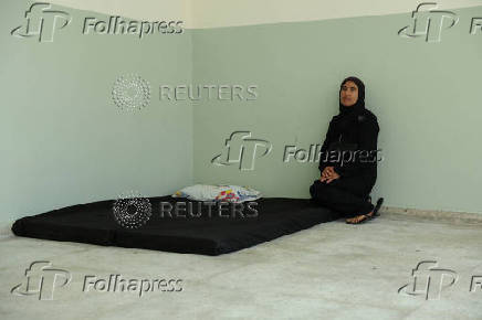 Rima Ali Chahine sits inside a class room at the Technical Institute of Bir Hassan, which has been turned into a shelter, in Beirut