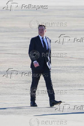 Tesla CEO and X owner Elon Musk walks on the tarmac