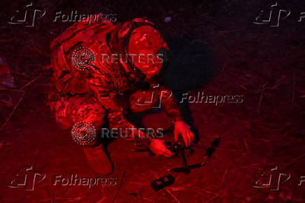 Policeman of the 'Khyzhak' Brigade prepares a drone for a flight at a position in a front line near the town of Toretsk