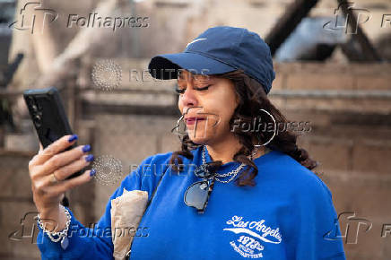 Desiree Johnson views her home that was destroyed by the Eaton Fire in Altadena