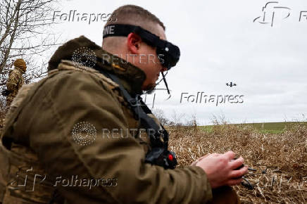 Ukrainian servicemen practice with an FPV drone, in Kharkiv region