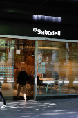 A man walks into a branch of Spain's Sabadell bank in the Gran Via of Bilbao
