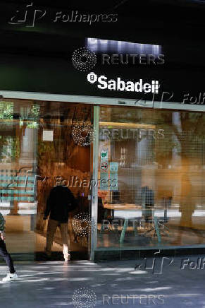 A man walks into a branch of Spain's Sabadell bank in the Gran Via of Bilbao