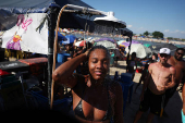 A woman cools off in a shower at the artificial pond known as Piscinao de Ramos in Rio de Janeiro