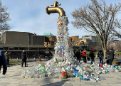 FILE PHOTO: Prop depicting a water tap with plastic bottle pollution is displayed by activists in Ottawa