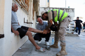 A medic assists an internally displaced person at a shelter in Beirut