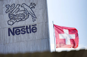 A Swiss flag flutters on the headquarters of Nestle in Vevey