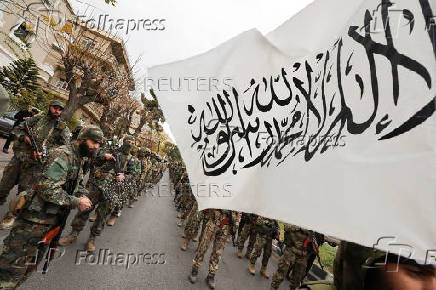 Khaled Brigade, a part of Hay'at Tahrir al-Sham (HTS), hold a military parade, in Damascus