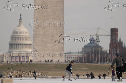 People skate on the ice-covered Lincoln Memorial Reflecting Pool on the National Mall, in Washington