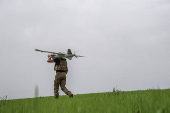 Ukrainian serviceman carries a reconnaissance UAV before flying in a front line in Donetsk region